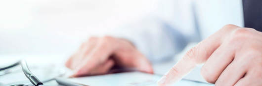 Cropped image of a doctor working on his digital tablet.He is showing digital tablet with blank screen