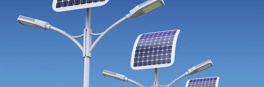 solar-powered streetlights shown in the daylight with blue sky background