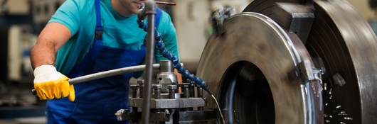 Man using metal cutting machine in factory