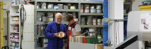 Workers looking at a paint can