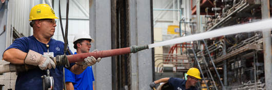 Photo of men in hardhats testing fire doors 