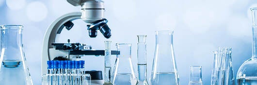 Microscope with glass laboratory equipment