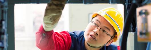 Person inspecting machinery