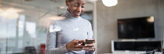 Business woman using cellphone in office to make payment