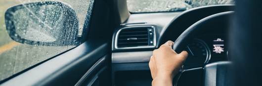 Man driving car in rain