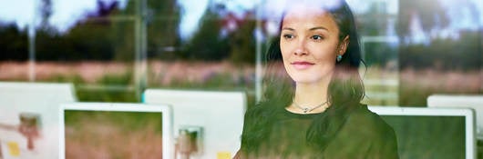 Woman looking outside a window at work 