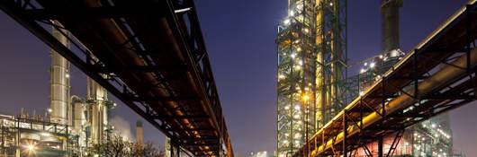 Pipelines at refinery at night