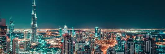 Nighttime skyline of big city illuminated by skyscrapers