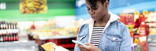 Woman scanning a label at the grocery store