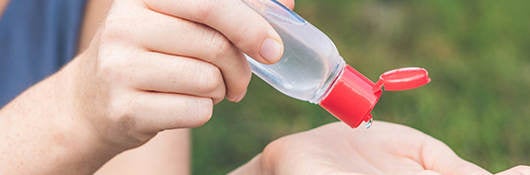 Woman using hand sanitizer 