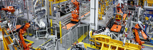 Robots putting cars together in a factory