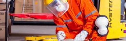 Industrial worker using grinder