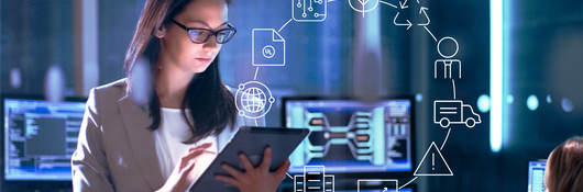 Female scientist sitting in front of computer screens