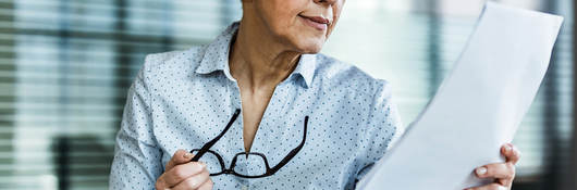 Woman looking at market share documents 