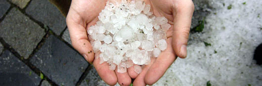 Two hands holding hail stones