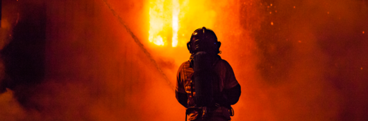 Firefighter and fire at night