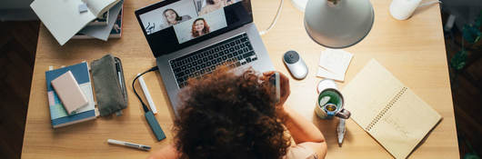 Woman on laptop learning and interacting with others