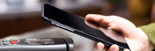 Mobile phone over a terminal being used for a contactless payment 