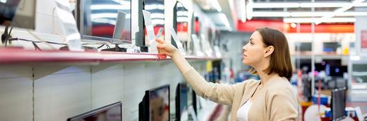 woman buying a TV in a retail store