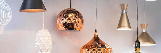 A variety of lighting fixtures hanging together in a retail setting.