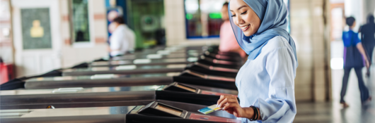 woman tapping a card on the ticket gate