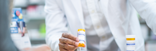 Pharmacist speaks with patient about prescription medication