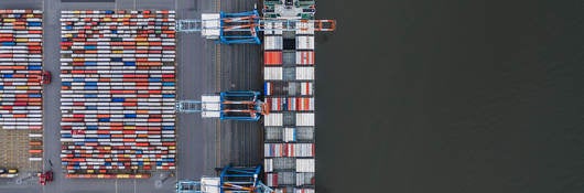 Container ship docked in port as seen from above