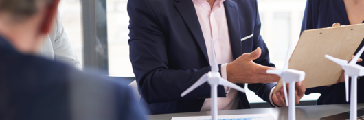 Business people discussing a wind turbine model