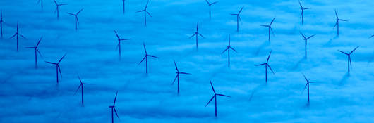 A wind farm in a sea of blue clouds