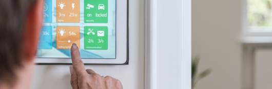 Woman operating touchscreen for smart home operation