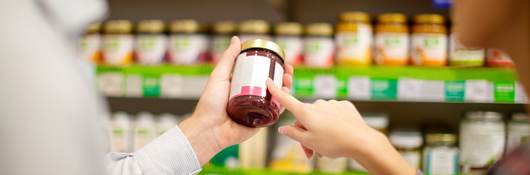 Woman holding jar at grocery store