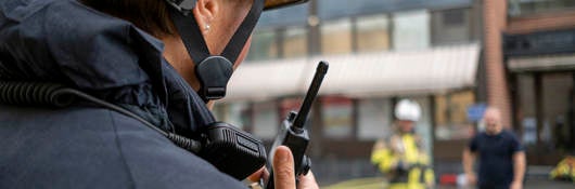 Firefighter with a radio device outside of a building