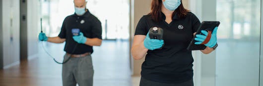 Two UL insprectors in masks conducting indoor air quality testing