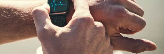 Man checking heart rate on a smart watch