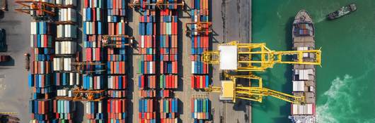 Overhead view of shipping containers being moved from a ship