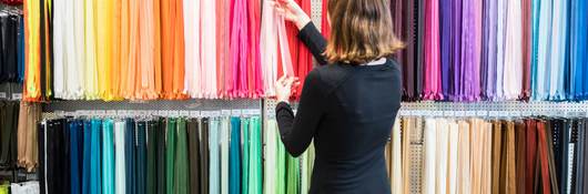 Woman examining colorful zippers