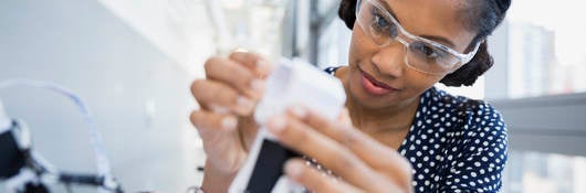 Woman looking into a microscope 