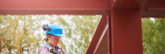 Steelworker tightening bolts