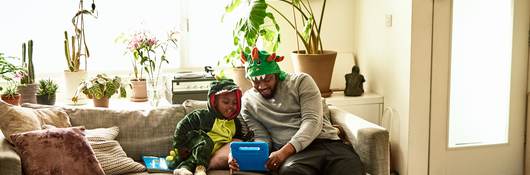 Father and son playing with a connected toy