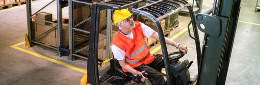 Worker driving a forklift