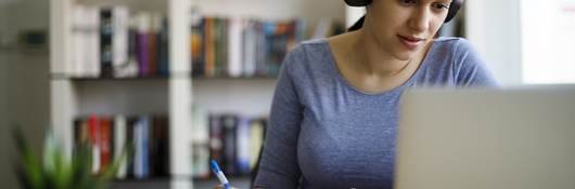 Woman in headset taking an e-learning course