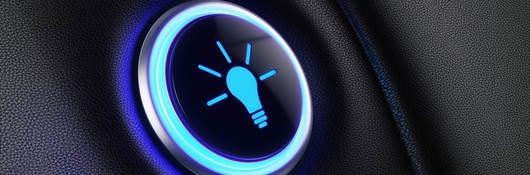 Image of a button with lightbulb icon glowing blue.