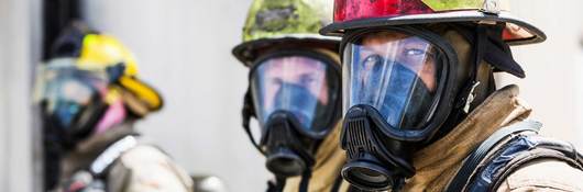 Three firefighters wearing protective equipment