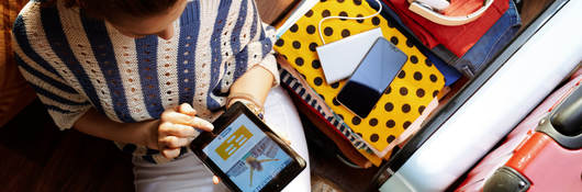 Upper view of a woman in white pants and striped blouse at modern home on the phone.