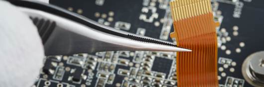 Human hand repairing printed circuit board