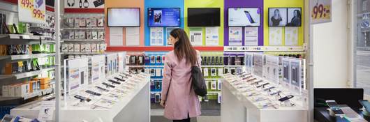 Woman browses products in an electronics store.