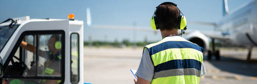 airport worker working with Lithium-ion battery-powered ground support vehicle