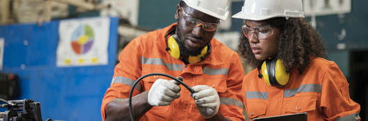 Engineers wearing hard hats and working together