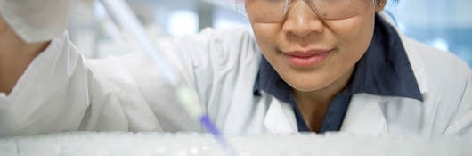 Scientist using a pipette