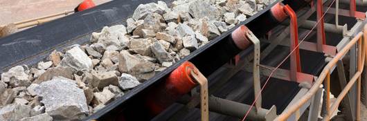 Raw material on conveyor belt before being crushed at copper mine in northern Chile.